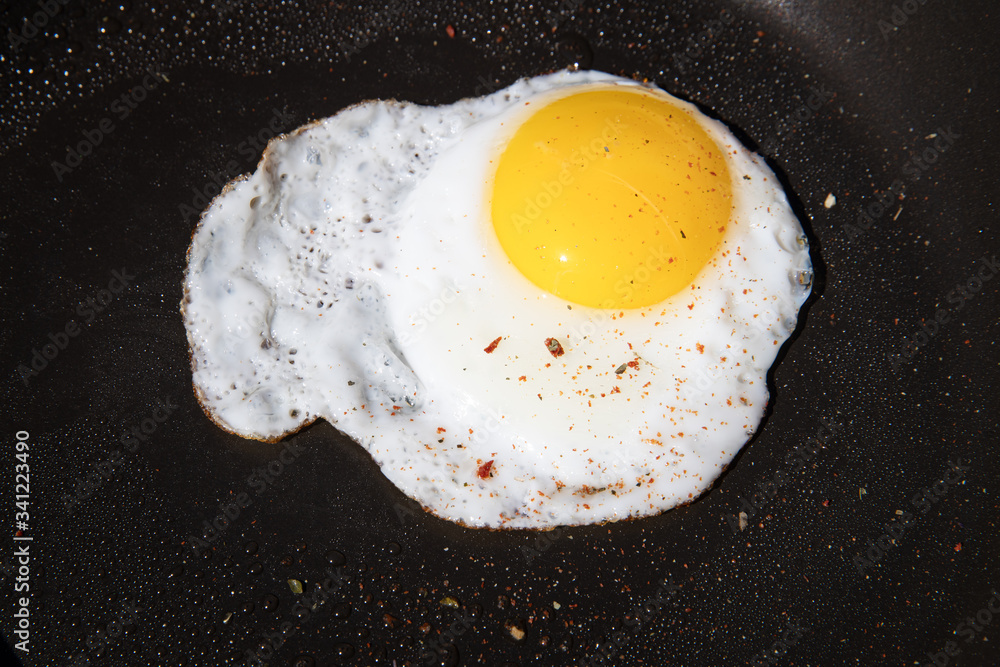 Scrambled egg on black pan background Scrambled egg on black pan background