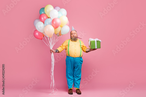 Full length body size view of his he nice funky bearded guy holding in hands bunch air ball giftbox whistling single alone lonely party time isolated over pink pastel color background photo