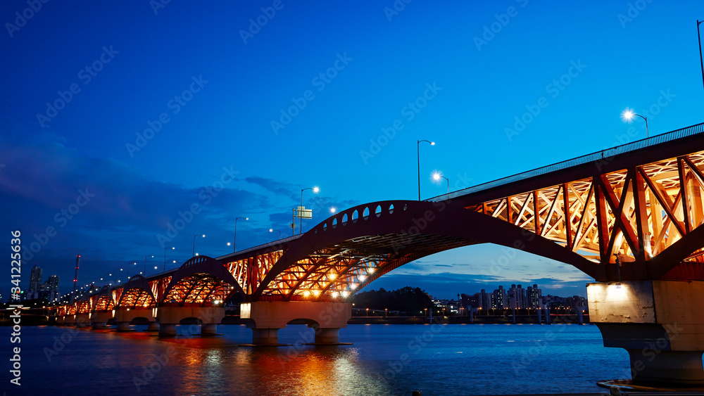 Fototapeta premium Lighting up bridge over the river