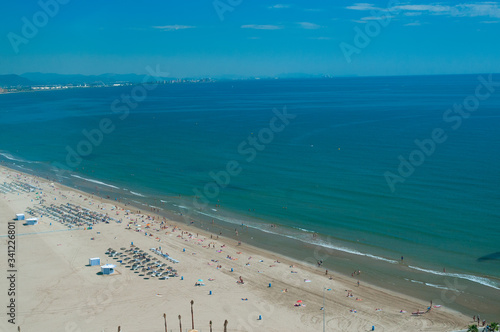 View above on sandy beach with tourists in sunny day © unclepodger