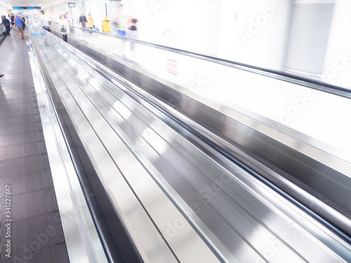 skywalk with blurred business people in airport