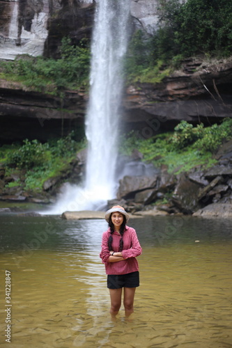 Women play in the water and fish around at Huai Luang Waterfall in Phu Chong–Na Yoi National Park Ubon Ratchathani, Thailand © pantkmutt