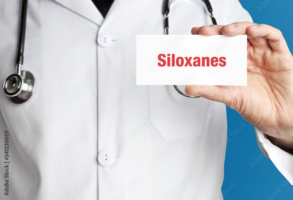 Siloxanes. Doctor in smock holds up business card. The term Siloxanes is in the sign. Symbol of disease, health, medicine Siloxanes. Doctor in smock holds up business card. The term Siloxanes is in the sign. Symbol of disease, health, medicine