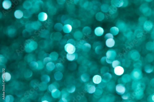 Shiny blurry green glitter textured background