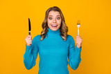 Photo of attractive charming wavy lady hold metal knife fork ready to start tasty food dinner meal good appetite wear blue turtleneck isolated bright yellow color background