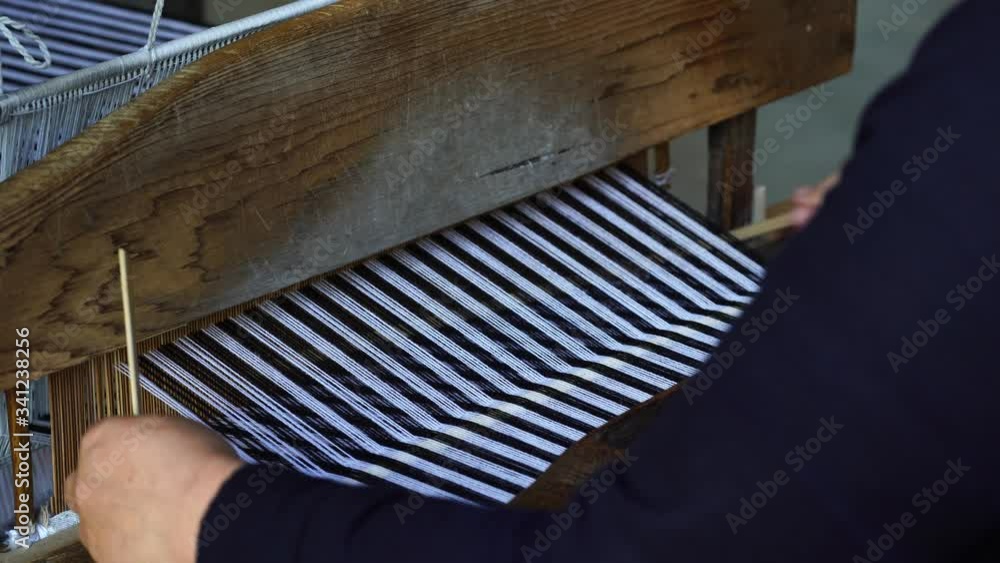 Traditional Vietnamese textile manufacture in craft village where old women work on wooden