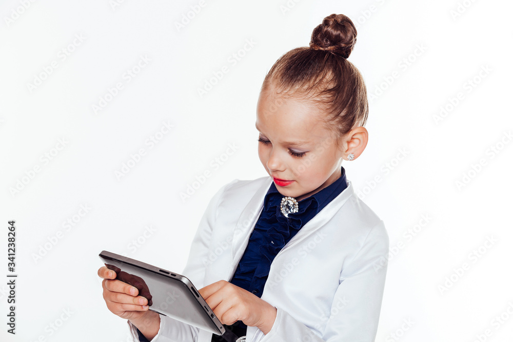 little girl looks at Internet Tablet business woman little girl looks at Internet Tablet business woman