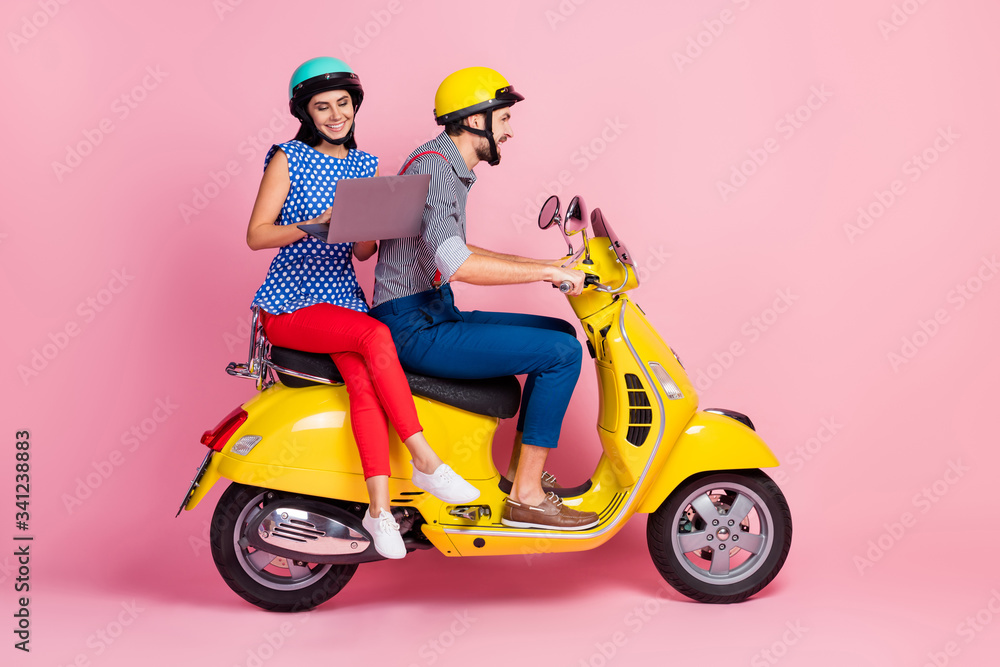 Full length photo positive cheerful wife husband two people motorcyclist riders drive yellow choppers woman browse internet want find perfect adventure place isolated pastel color background