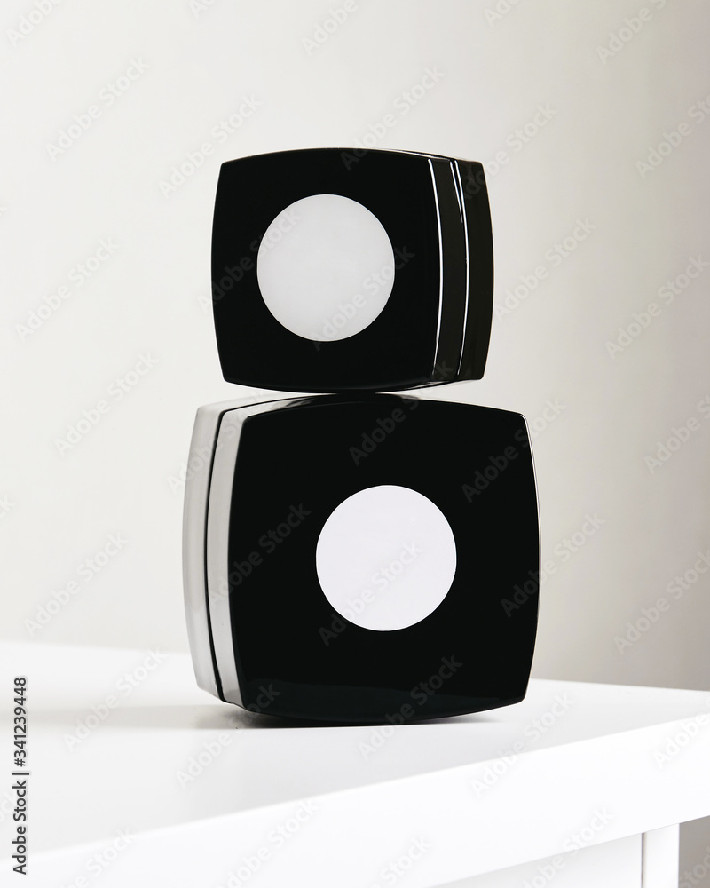 Blank cosmetic package mockup on light background set. Black boxes for hand cream. Empty label, copy space Blank cosmetic package mockup on light background set. Black boxes for hand cream. Empty label, copy space