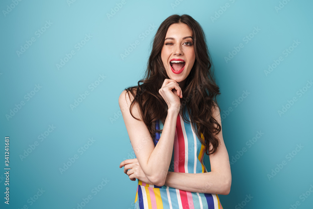 Photo of excited cute woman posing at camera and winking Photo of excited cute woman posing at camera and winking