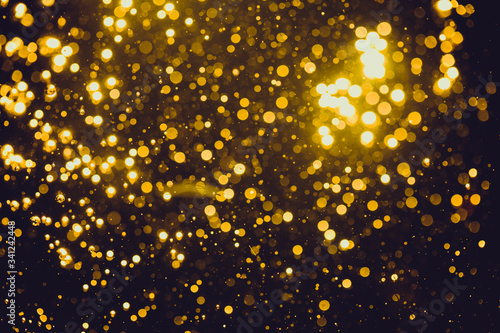 Abstract gold defocused bokeh of lights in dark © pandaclub23