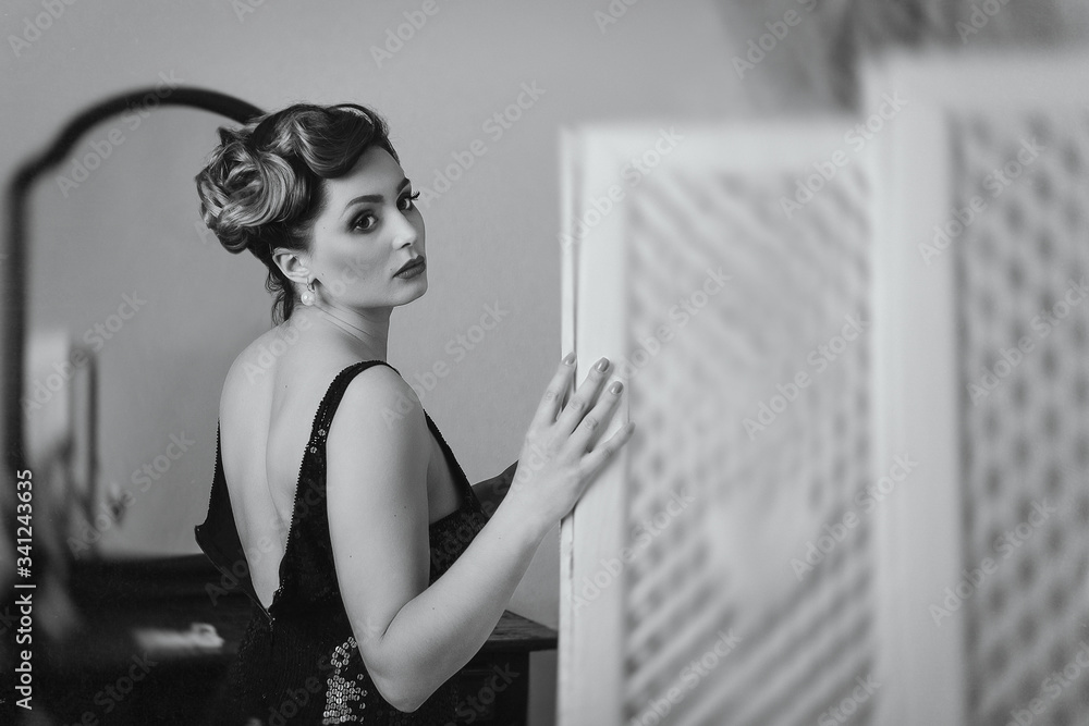 young brunette model girl and actress near the screen, black and white young brunette model girl and actress near the screen, black and white