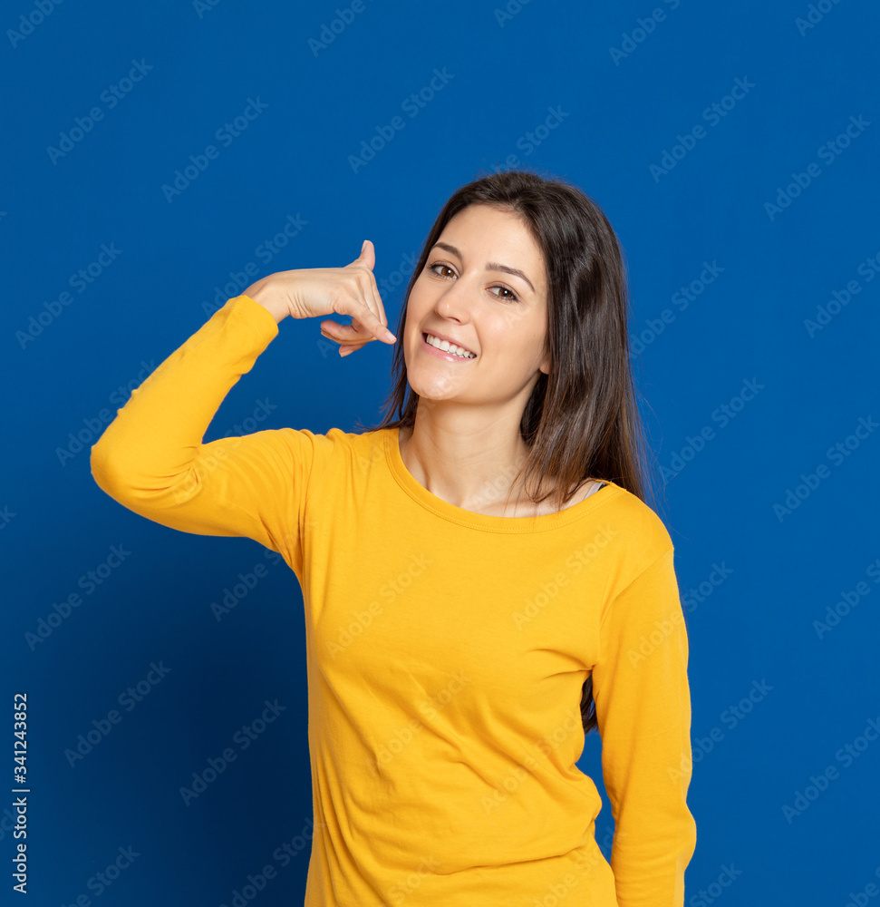 Brunette young woman wearing a yellow T-shirt Brunette young woman wearing a yellow T-shirt