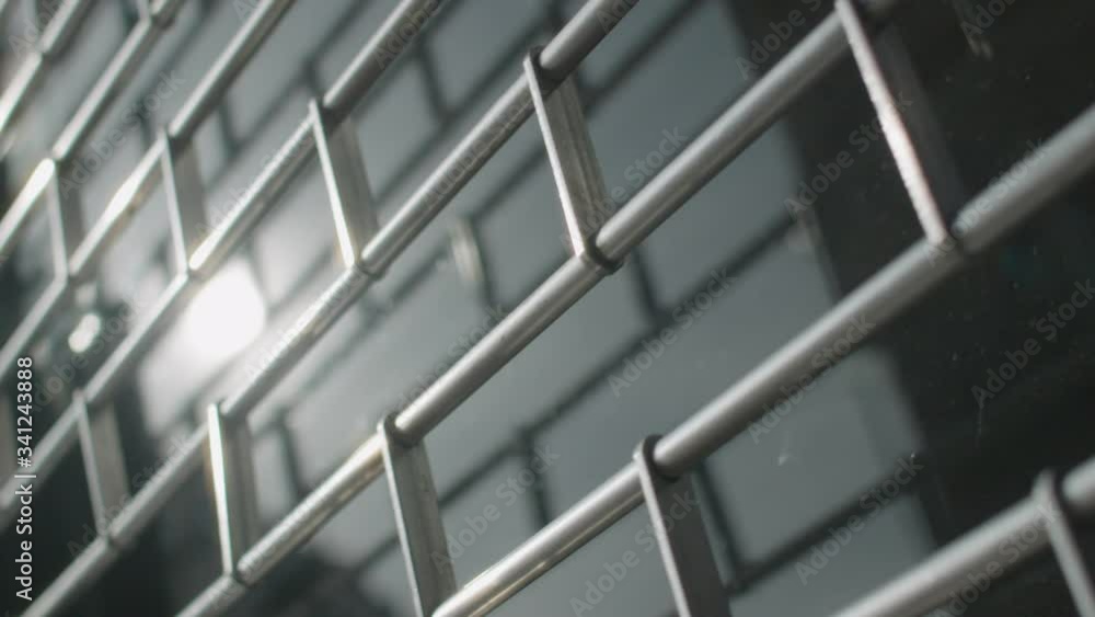 Slow motion of metal security shutter over a shop or office window. Abstract reflective metallic sufaces and shapes Slow motion of metal security shutter over a shop or office window. Abstract reflective metallic sufaces and shapes