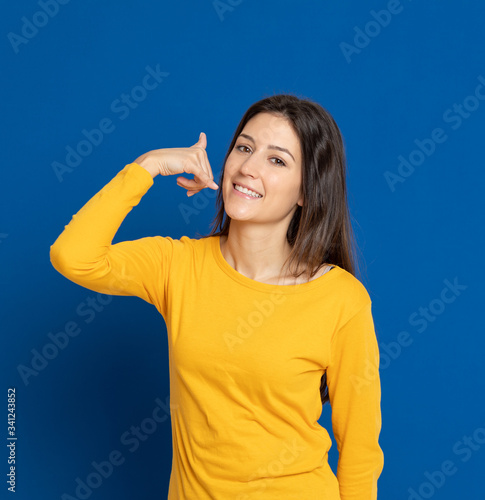 Brunette young woman wearing a yellow T-shirt