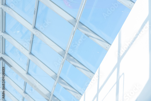 Clean roof windows and blue sky. Element of a modern glass roof of a shopping mall or airport  abstract image