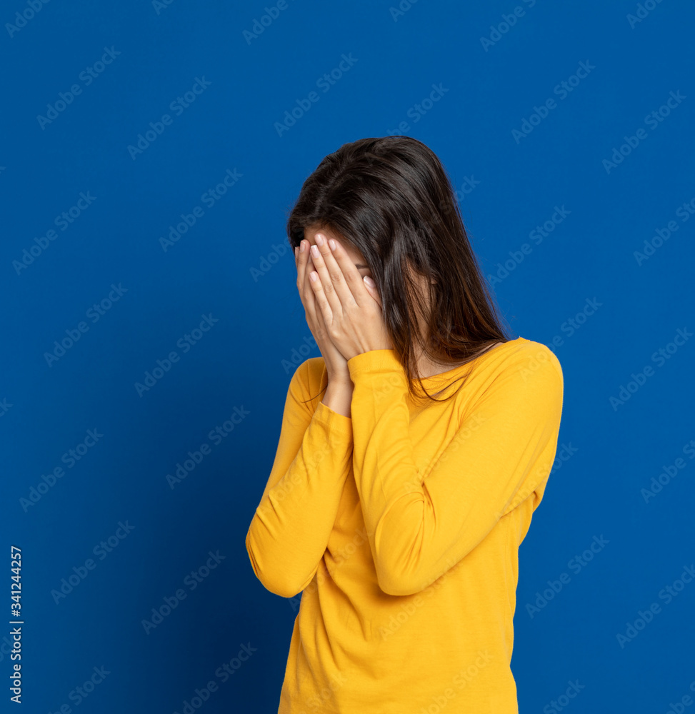 Brunette young woman wearing a yellow T-shirt Brunette young woman wearing a yellow T-shirt