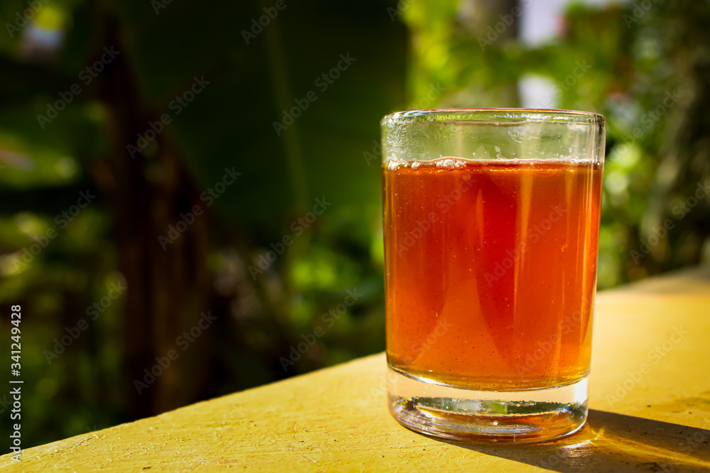Outdoor Tea pouring into glass cup transparent with day sunlight.
Outdoor Tea pouring into glass cup transparent with day sunlight.