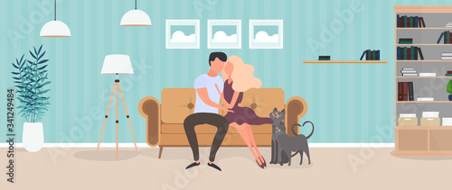 Loving couple sitting on the sofa in the room. Lovers hug each other. Suitable for the design of cards, banners and posters on the theme of love and Valentine's Day. Vector.