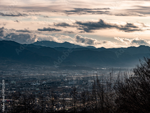 Sweeping views of a small Japanese town surrounded by mountains