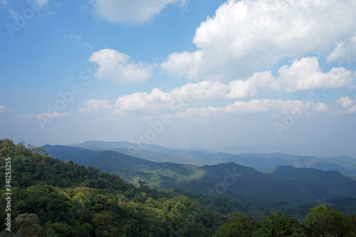 Natural landscape of green mountain range with cloudy blue sky