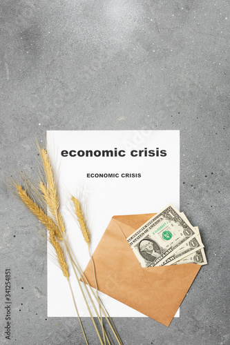Economic crisis. Three dollars in an envelope, ears of corn, and a piece of paper with the words 