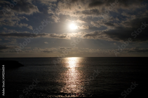  calm landscape with the setting sun over the ocean