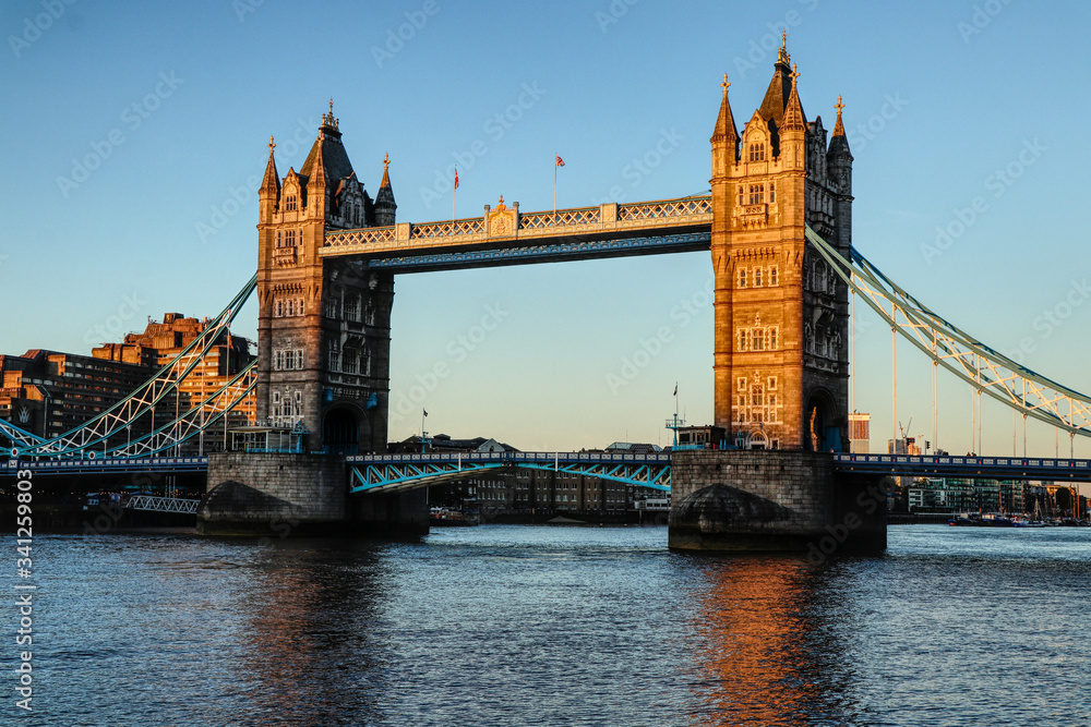 Obraz premium Wonderful and historical Tower bridge across Thames river during sunset and blue sky. Tower Bridge is a combined bascule and suspension bridge. Bridge consists of two bridge towers