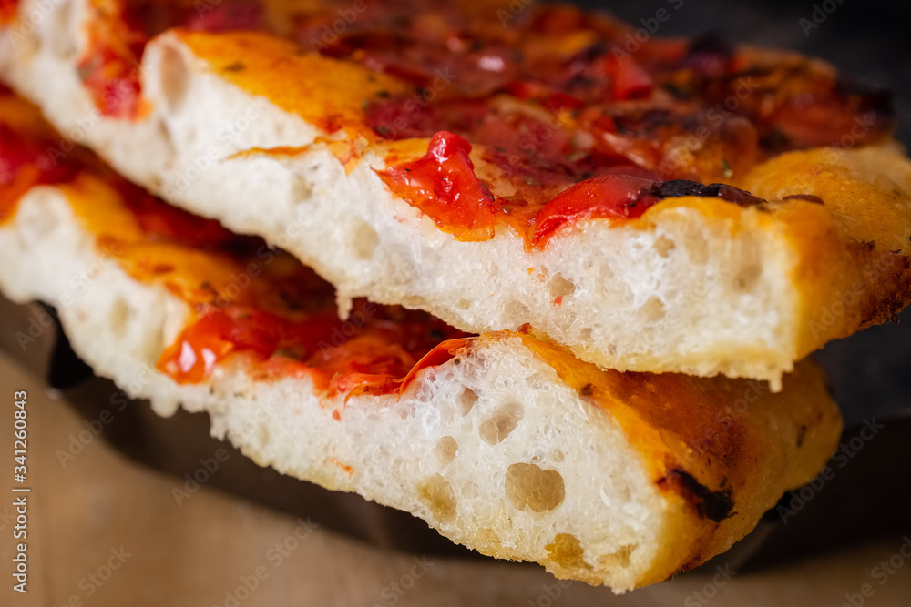 Close up of slices of delicious homemade focaccia barese bread with tomato Close up of slices of delicious homemade focaccia barese bread with tomato