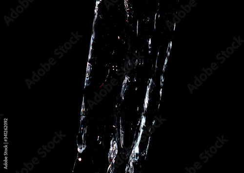 Water jet on a black background.