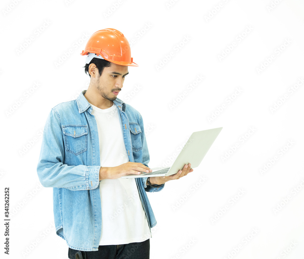 Smart young asian architect engineer man wear casual jean and orange safety helmet which hand holding laptop to check his plan work with serious and thinking position on white background studio shot. Smart young asian architect engineer man wear casual jean and orange safety helmet which hand holding laptop to check his plan work with serious and thinking position on white background studio shot.