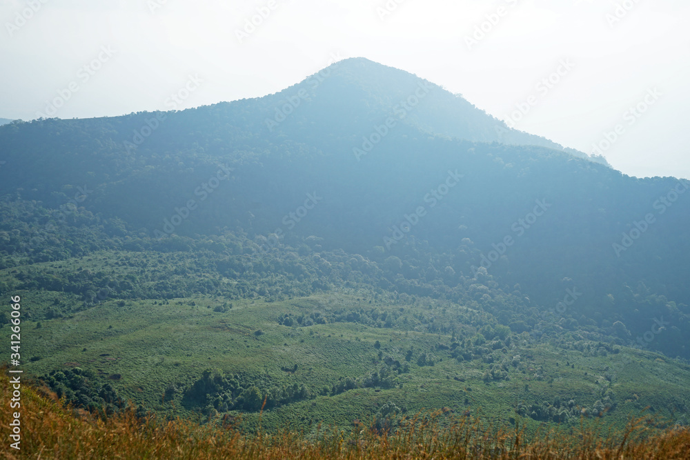 Natural landscape of green mountain range with cloudy blue sky