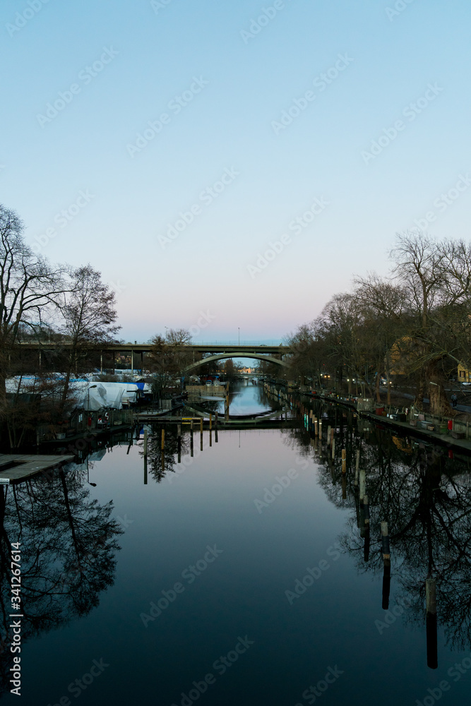 STOCKHOLM, SWEDEN; March 21 2019: Urban magical reflections in Swedish sunset. Långholmsbron bridge. STOCKHOLM, SWEDEN; March 21 2019: Urban magical reflections in Swedish sunset. Långholmsbron bridge.