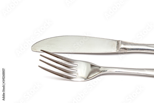 Steel fork and knife close-up on a white background