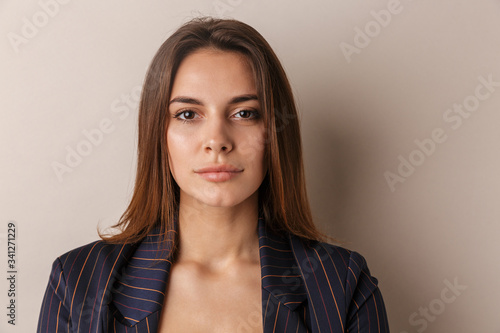 Obraz na plátně Photo of young businesswoman posing and looking at camera