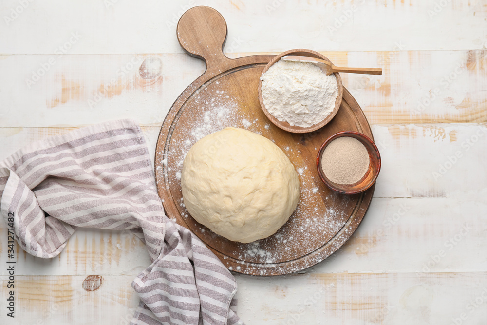Fresh dough with flour and yeast on table Fresh dough with flour and yeast on table