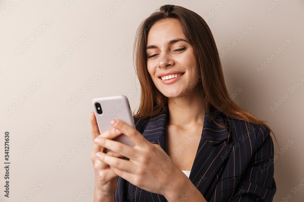 Photo of cheerful businesswoman laughing and using cellphone Photo of cheerful businesswoman laughing and using cellphone