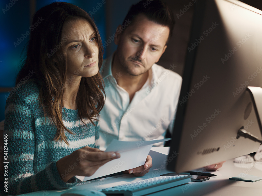 Couple checking a contract online Couple checking a contract online