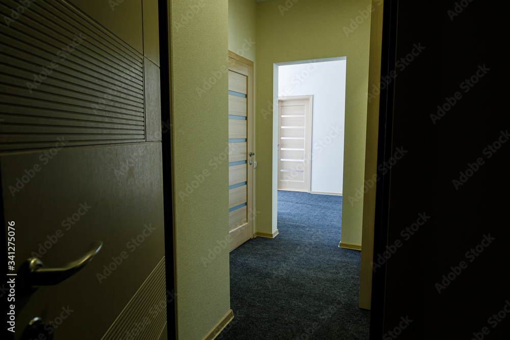 Long bright entrance hall with doors in a new hotel with wardrobe Long bright entrance hall with doors in a new hotel with wardrobe