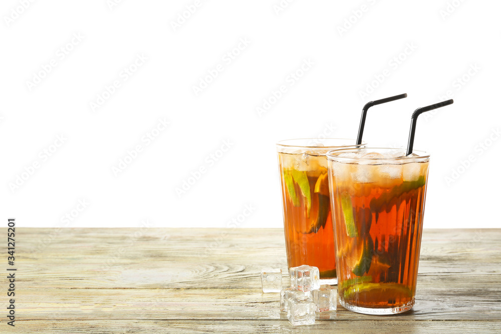 Glasses of tasty cold ice tea on table against white background Glasses of tasty cold ice tea on table against white background