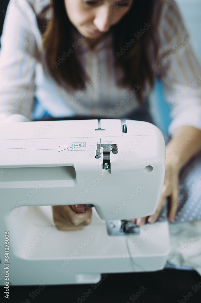 seamstress works on a sewing machine. factory. handmade