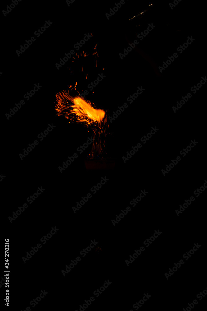 flame of fire with sparks on a neutral black background