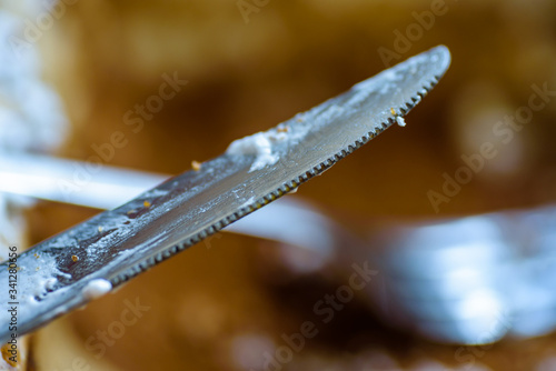 fork knife and spoon covered with apple pie icing on empty baking paper tray