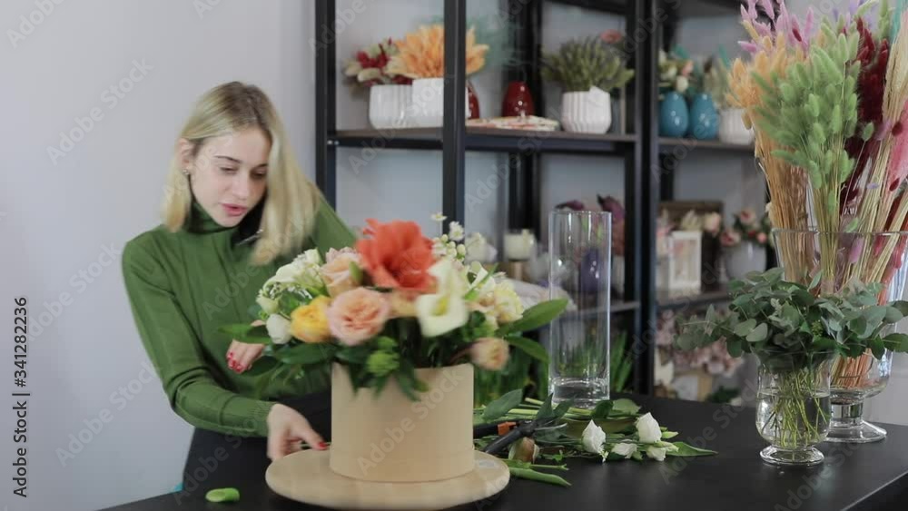 Florist woman make a beautiful flowers bouquet Florist woman make a beautiful flowers bouquet
