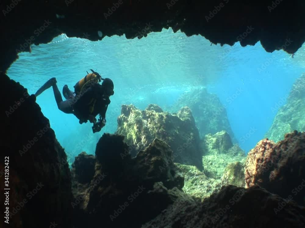 scuba divers are exploring the caves underwater cave dive ocean scenery ...