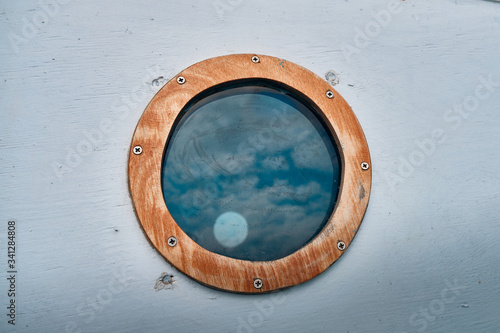 ship window or porthole on white wooden wall
