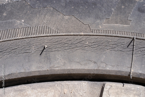 Car wheel, tire, cracked from old age. Close-up.