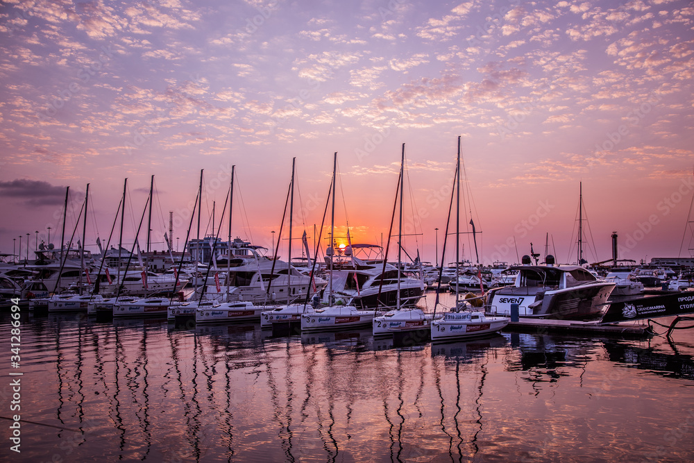 Yachts in the port at sunset