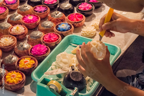 sculptor making flowers on soap at night market in Chiang Mai Thailand