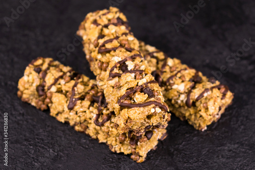 
Three useful granola diet bars on a black background.
Close-up.